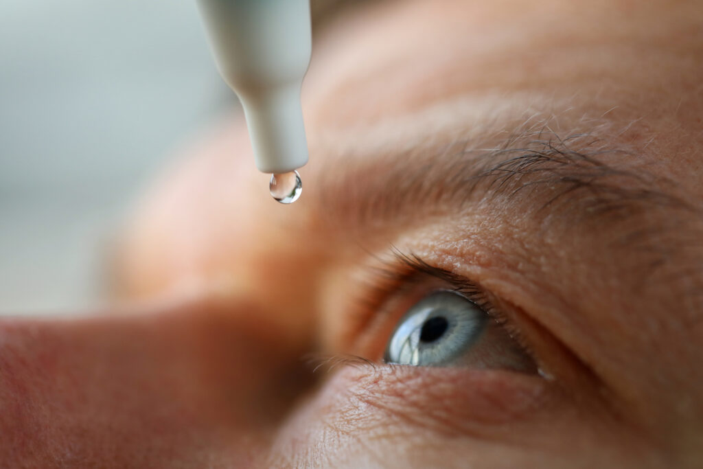 man drops eye drops install lenses, moisturizing
